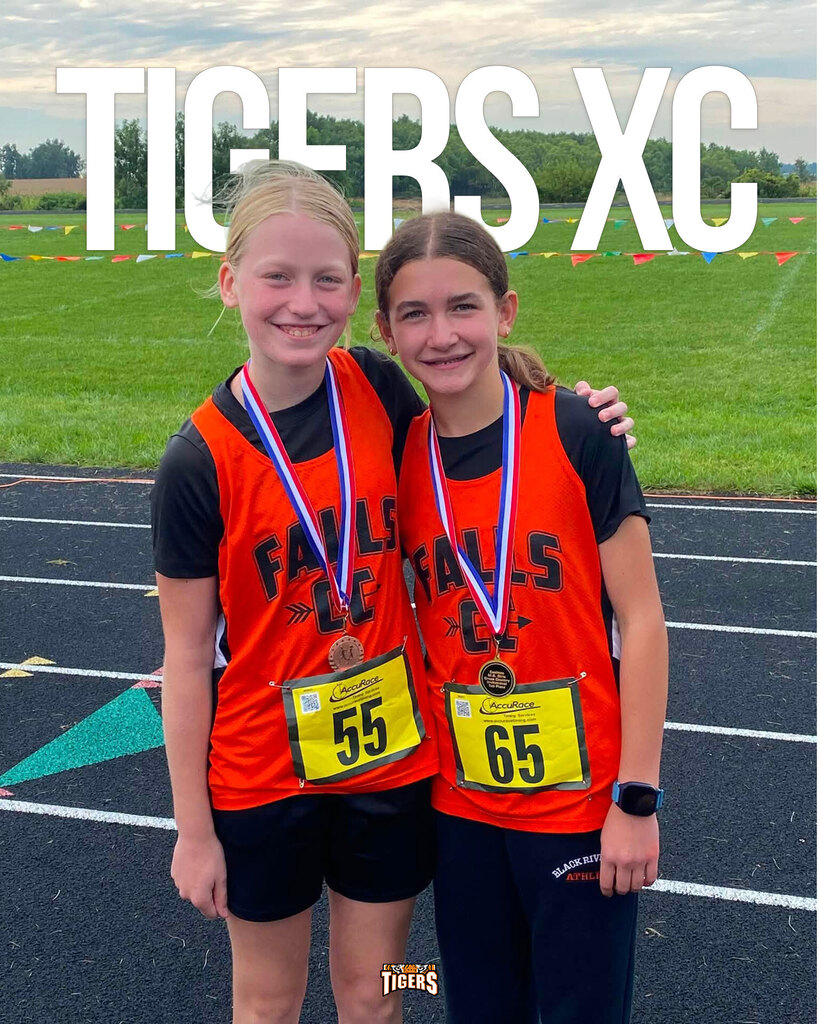 Photo of two girls in orange Falls CC singlets with arms around each other's shoulders. Text on image says "Tigers XC"