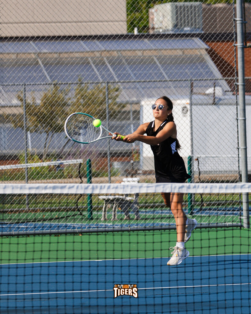 Tennis player hitting a ball.