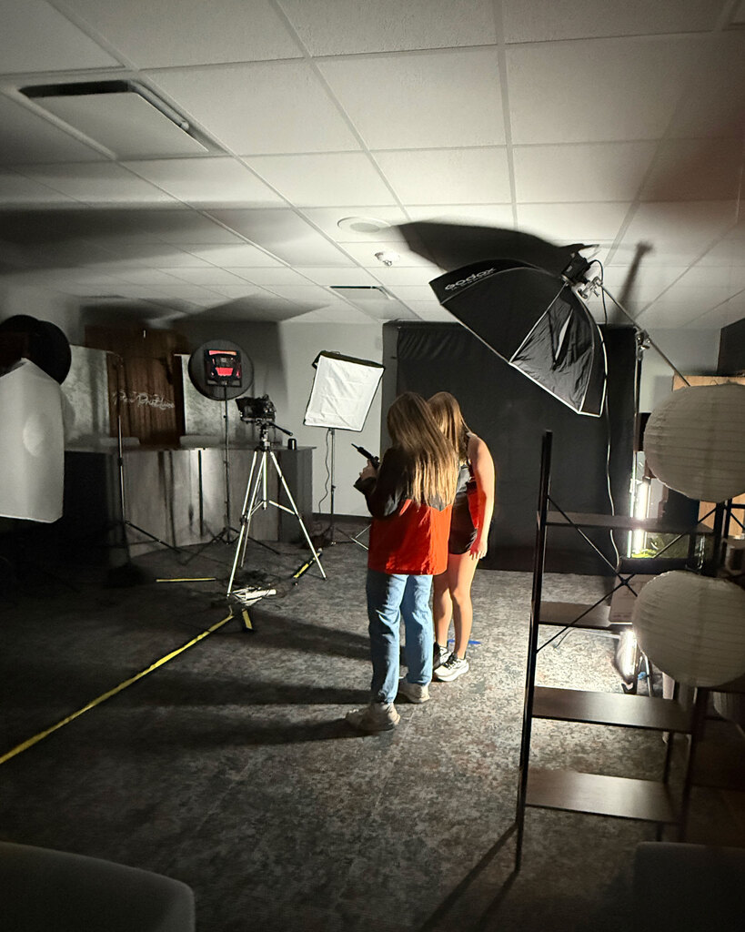 Two students look at a camera display.