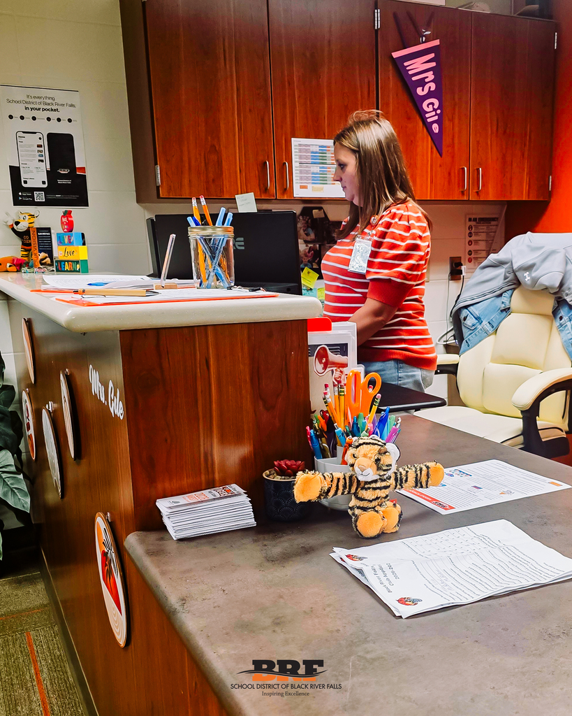 Tiger sits in front of a secretary while she works