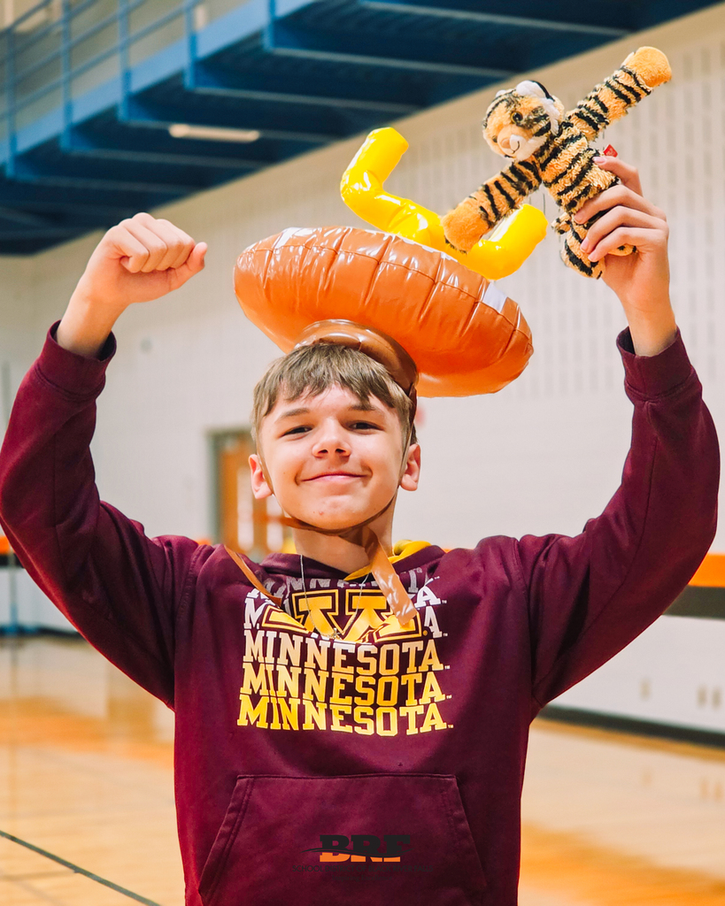 Student wears inflatable goalpost hat while holding stuffed Tiger