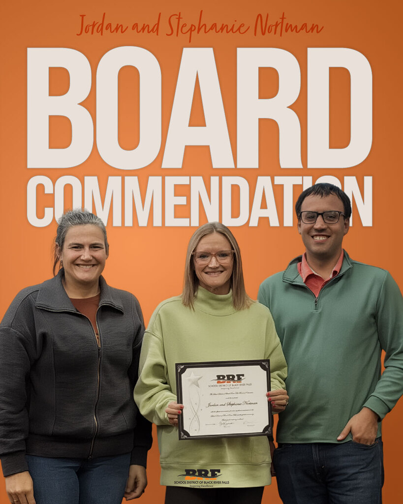 Three people standing together in front of an orange backdrop with the large white text "BOARD COMMENDATION" and "Jordan and Stephanie Nortman" at the top. The person in the center holds a framed certificate from the School District of Black River Falls.