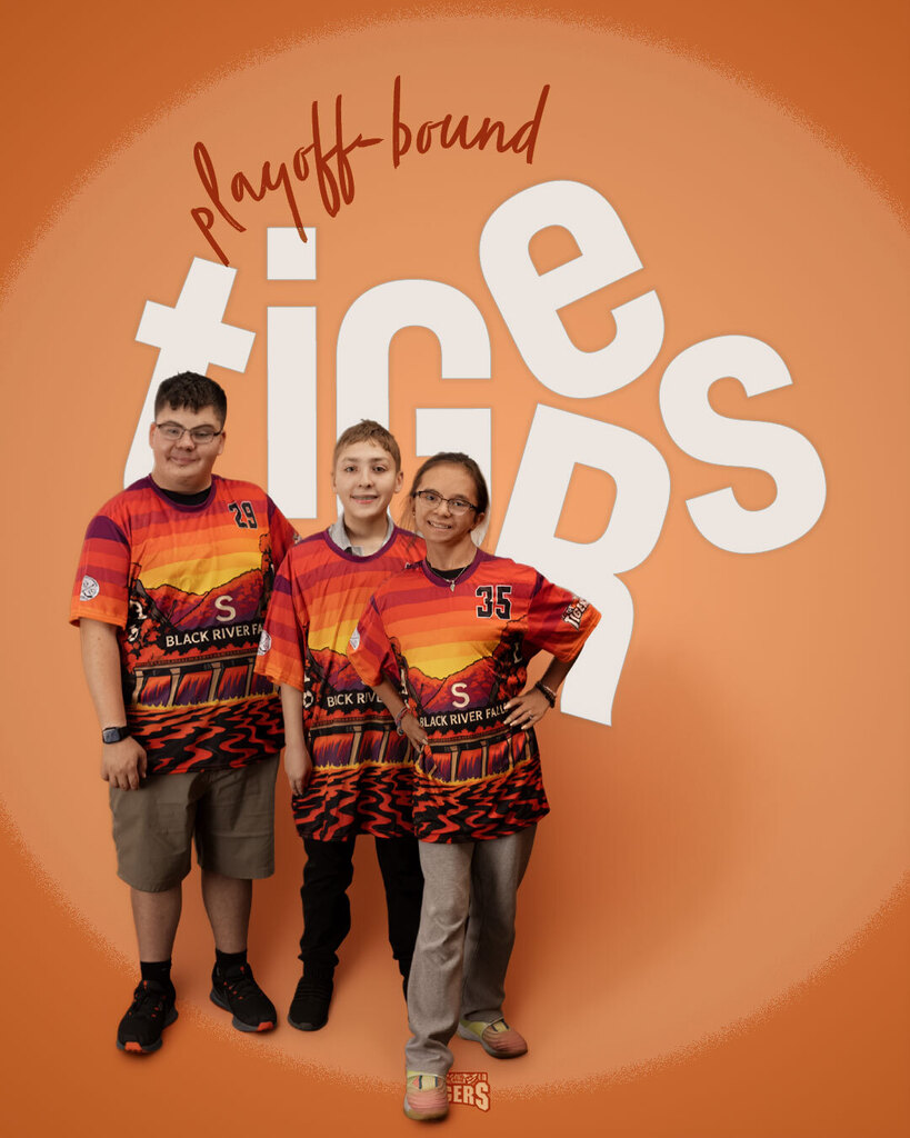 Three young people standing together in front of an orange background wearing matching Black River Falls Tigers team shirts, with "playoff bound" written in script and "TIGERS" spelled out in bold white text behind them.