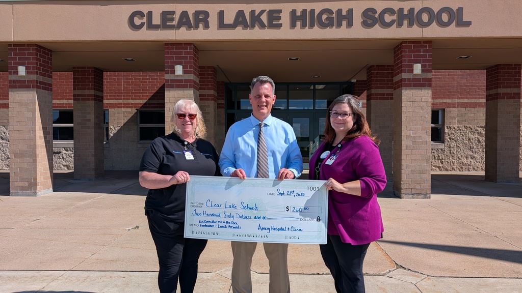 Three adults holding an oversized fake donation check