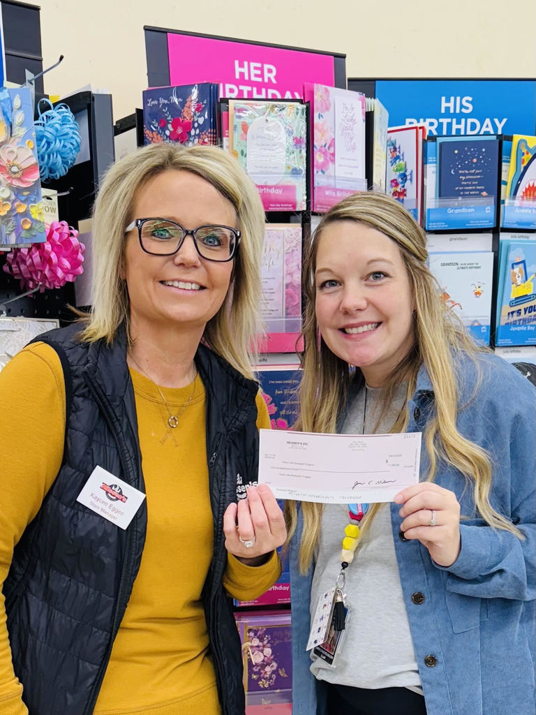 Pictured is Kaycee Eggen presenting the check to elementary school counselor, Jami Van Heuklom.