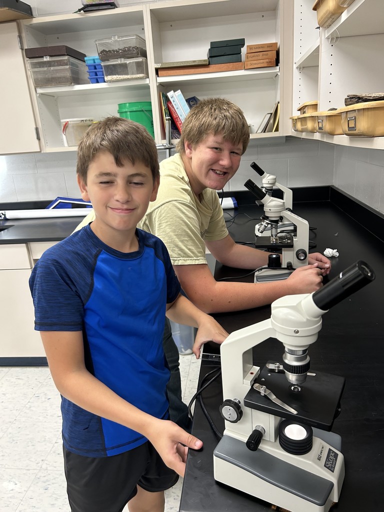7th Graders learning about microscopes
