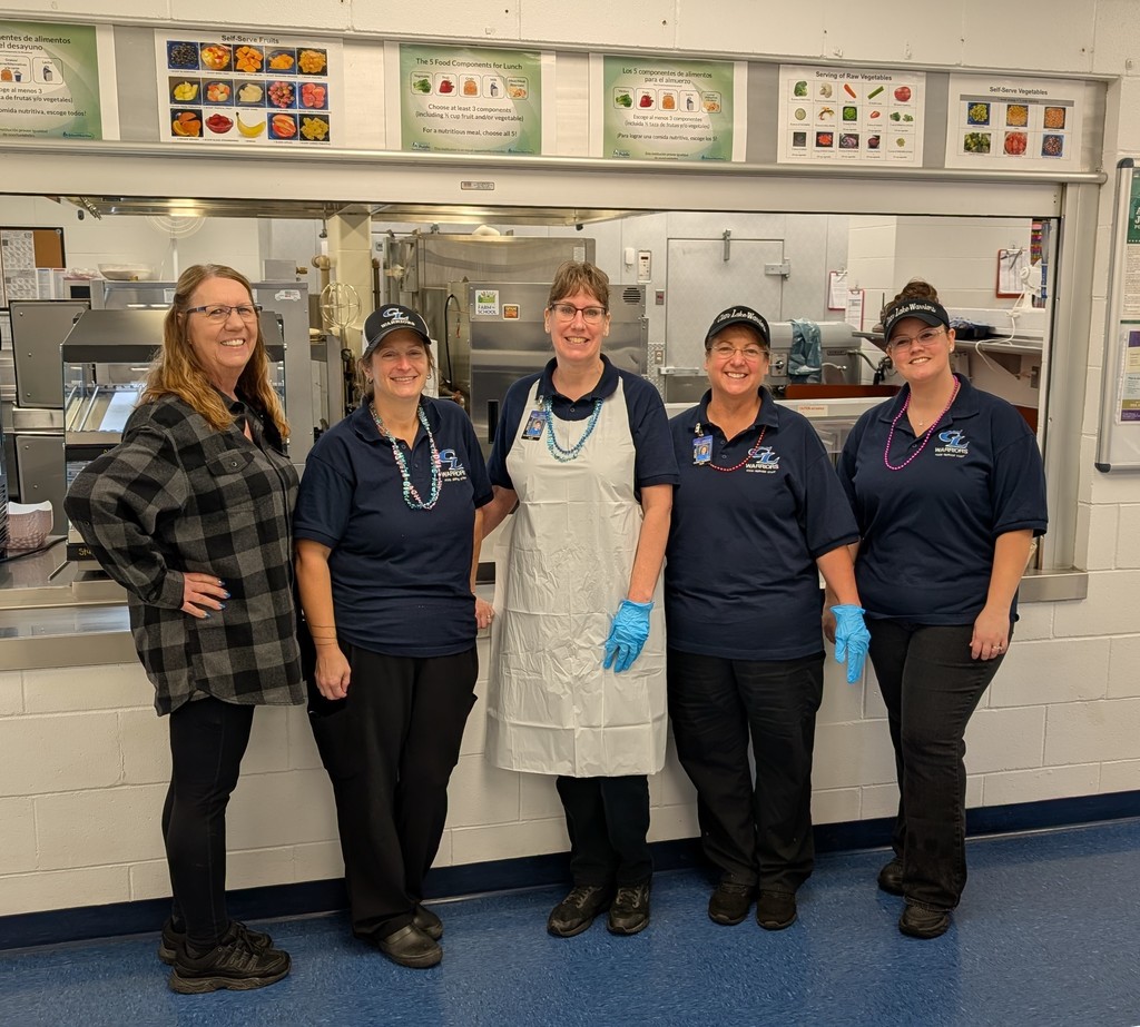 School cooks standing in front of serving line
