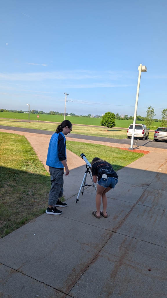 girl looking into telescope