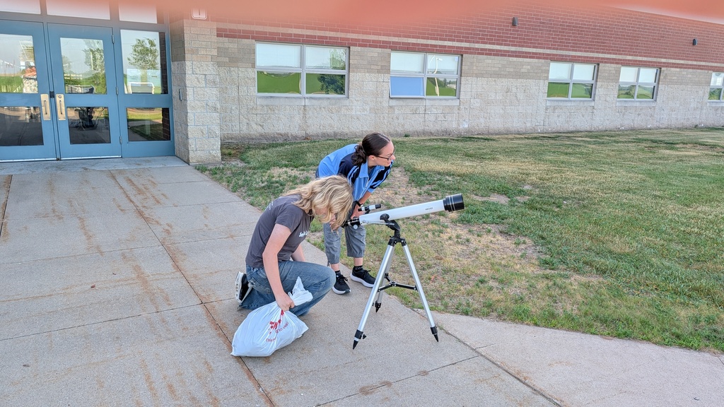 girl looking in telescope