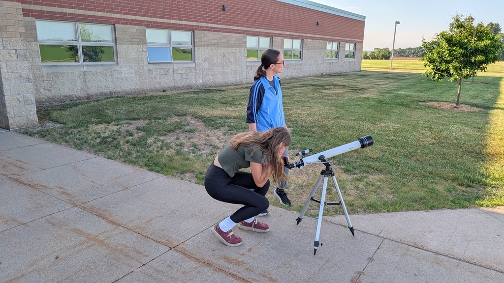girl looking in telescope
