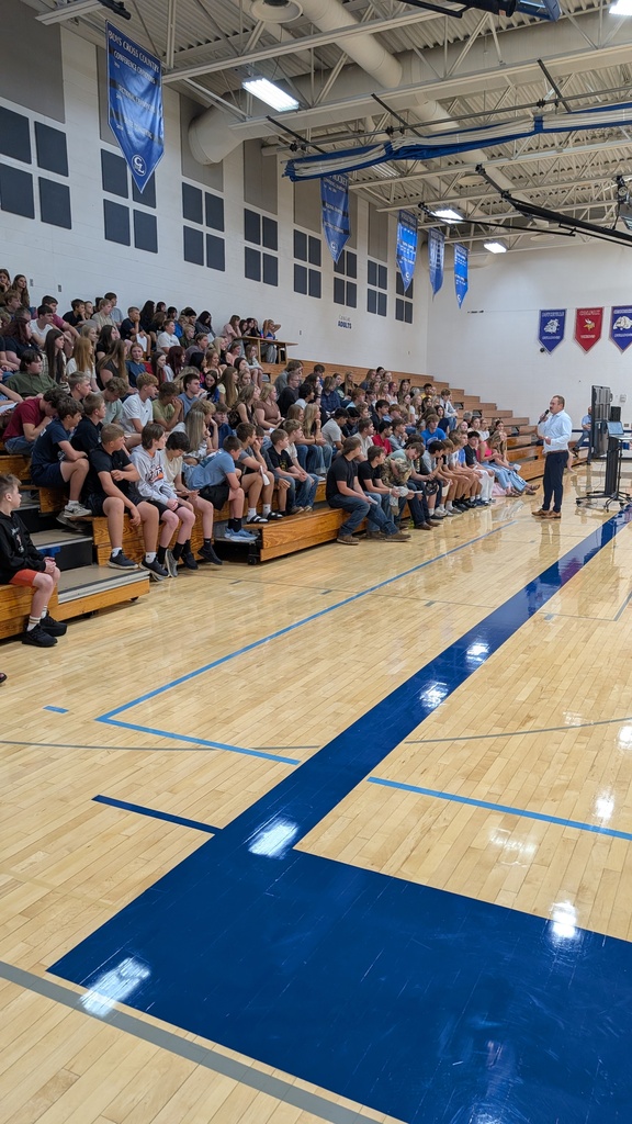 Gym full of students in bleachers