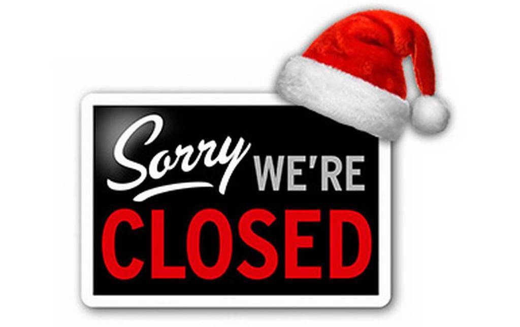 Alt text: “A black and white sign that reads ‘Sorry We’re Closed’ in bold red and white letters. A red and white Santa hat is placed playfully on the top right corner of the sign, giving it a festive Christmas theme.”