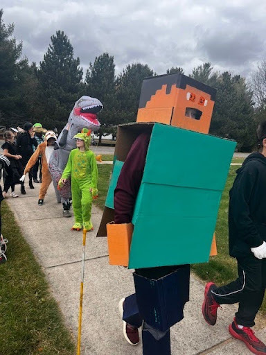 Students dressed up for Halloween walking on sidewalk
