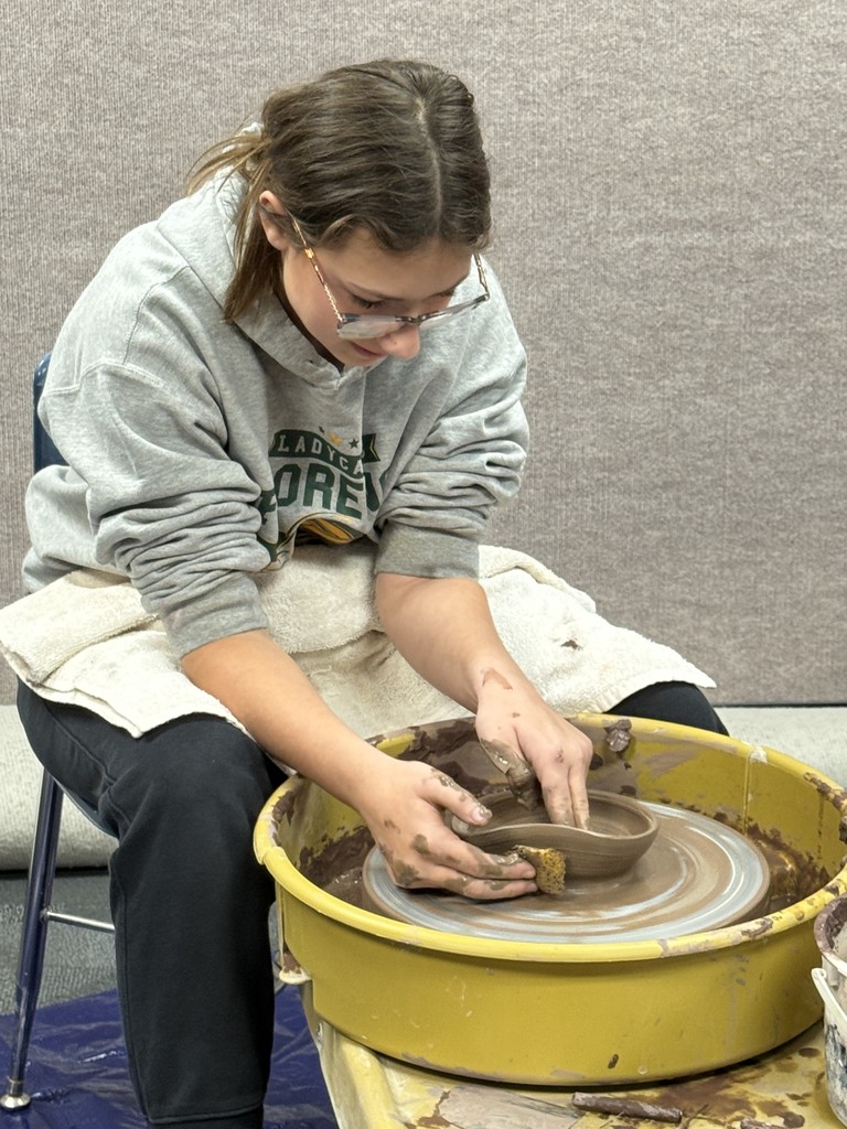Mikayla Wolf with Kenyon Hansen making pottery