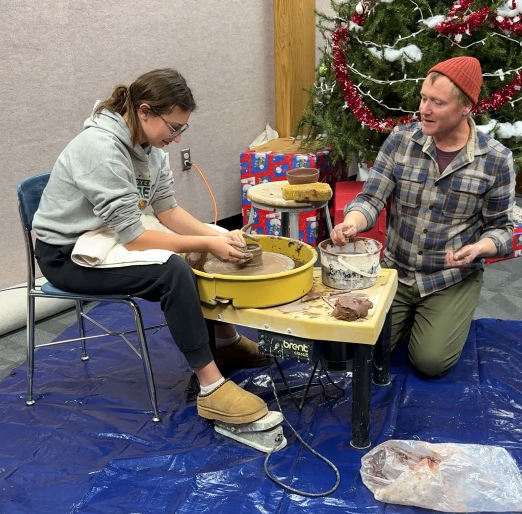 Mikayla Wolf with Kenyon Hansen making pottery