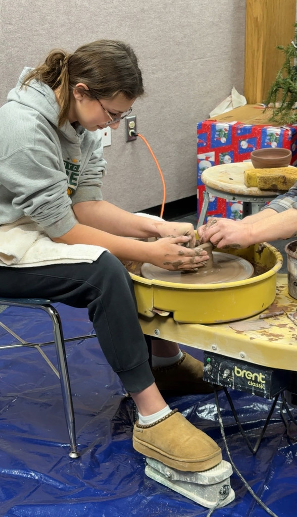 Mikayla Wolf with Kenyon Hansen making pottery