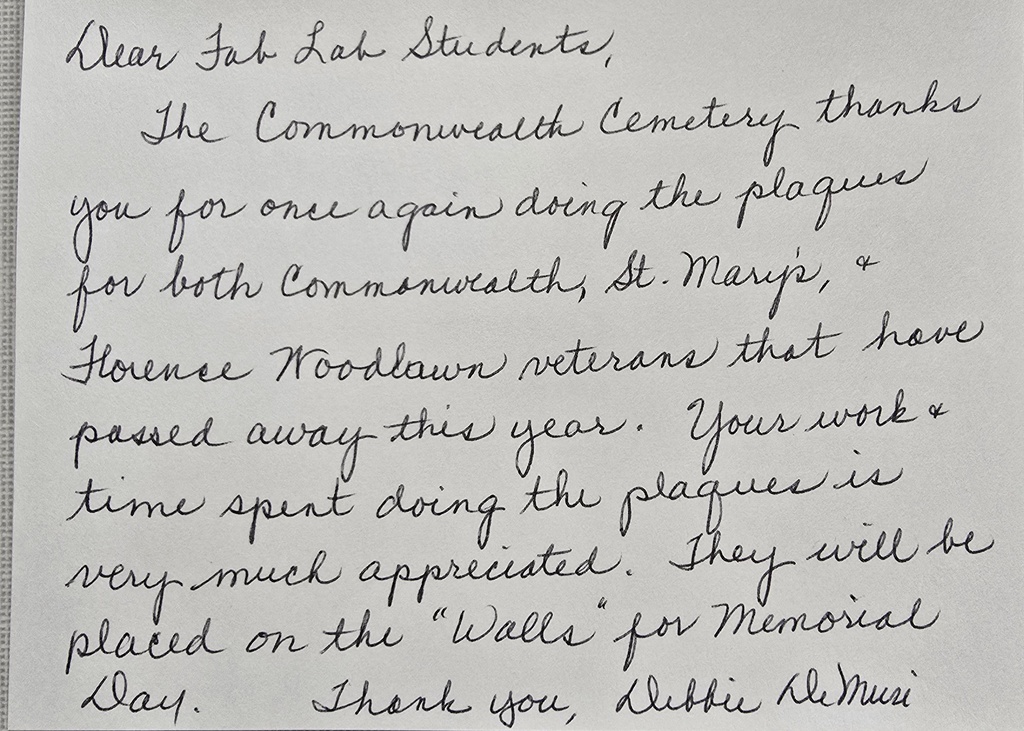 A handwritten thank-you note expressing appreciation to students for creating plaques honoring veterans from Commonwealth, St. Mary’s, Florence, and Woodlawn Cemeteries for Memorial Day.