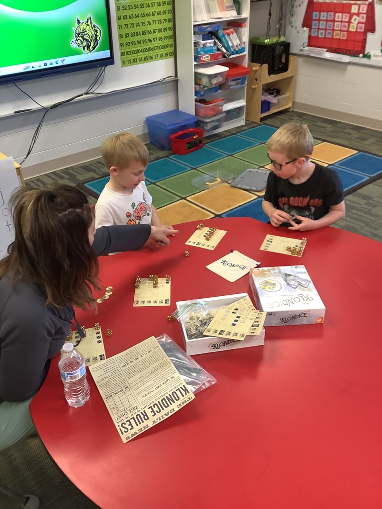 Parents and children playing games at Family Checkup night