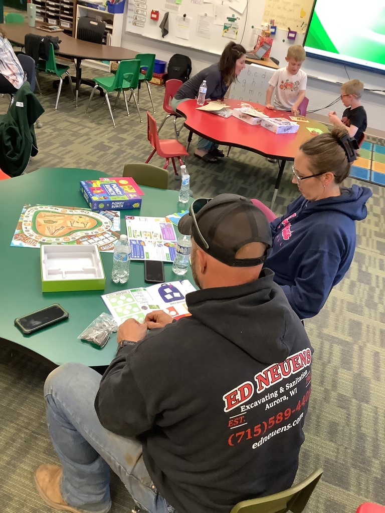 Parents and children playing games at Family Checkup night
