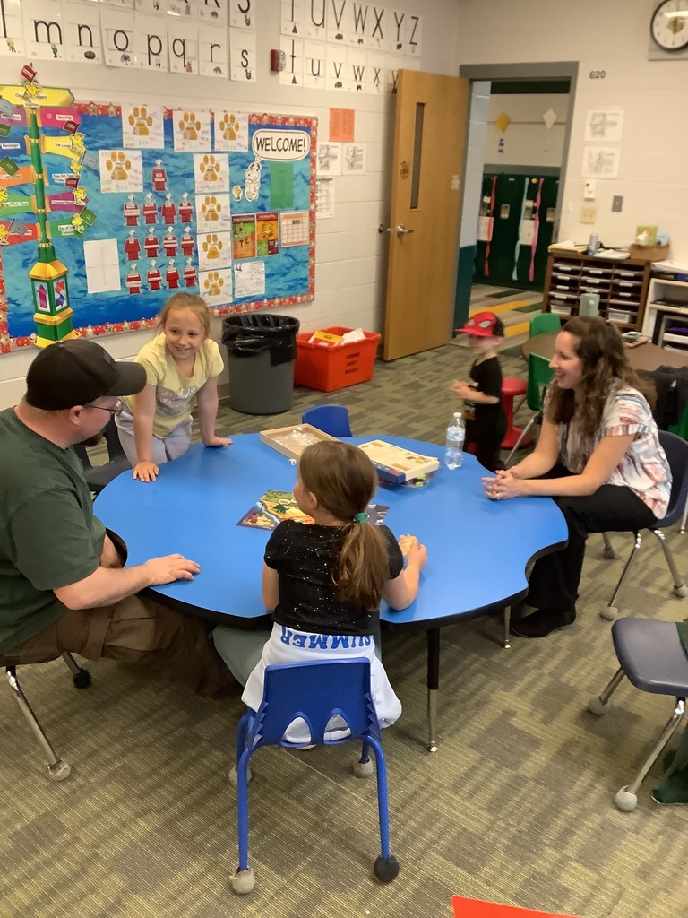 Parents and children playing games at Family Checkup night