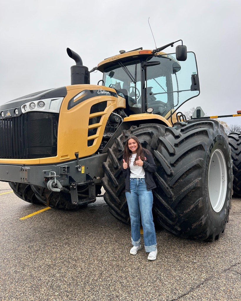 Pictured are Owen Kempf and Keilah Reu showing off their tractors and school spirit. 🌾