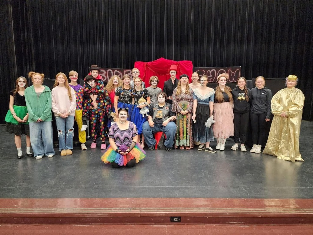 black stage, actors and actresses in various costumes