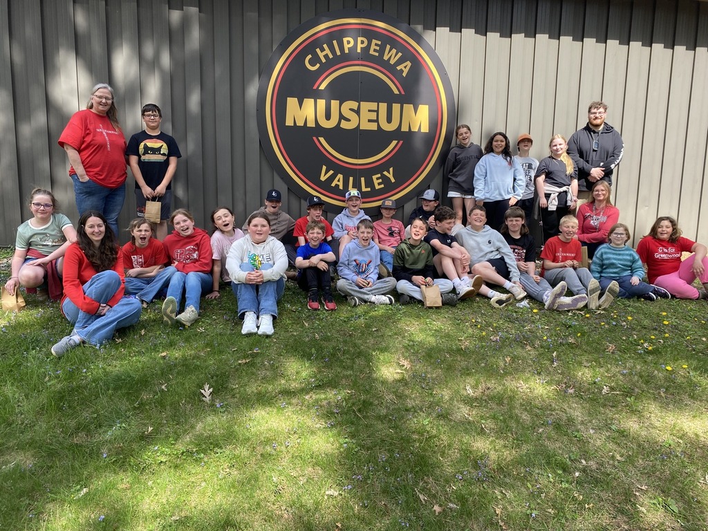 students sitting and standing in front of the Chippewa Valley Museum outside