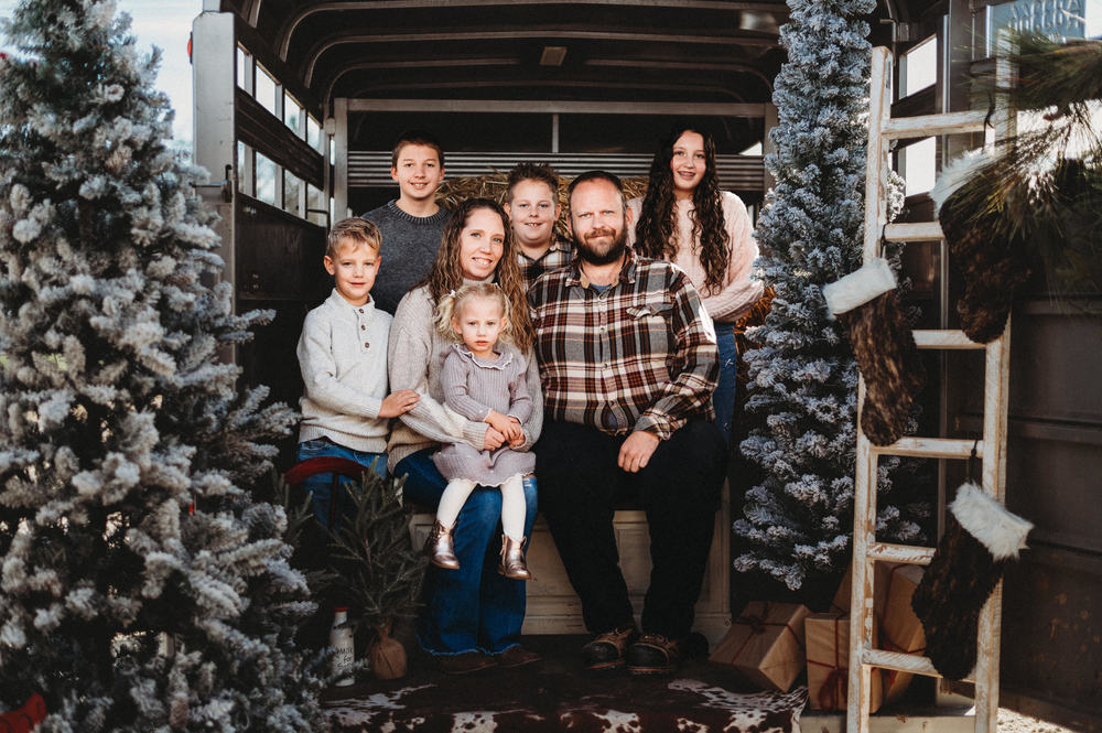 Samantha Schiefelbein and family pose with Christmas decor
