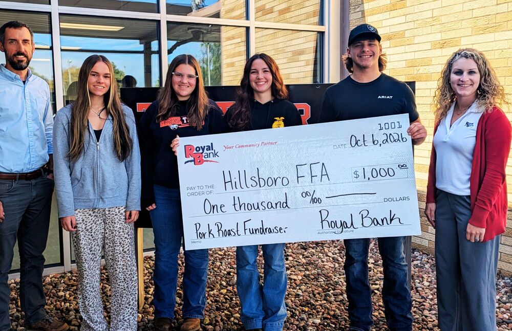 Students pose with check from Royal Bank