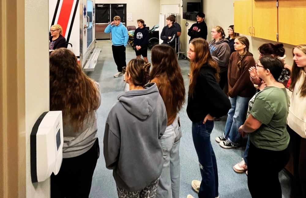 Students stand listening at Sparta Public Safety Training Facility