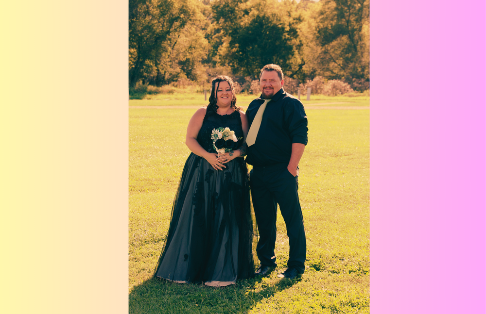 Allison poses with another person in a field