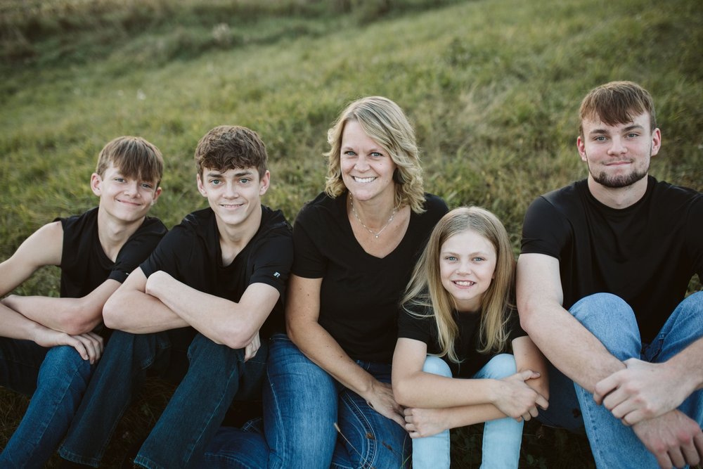 Cathy Wildes and family pose on grass