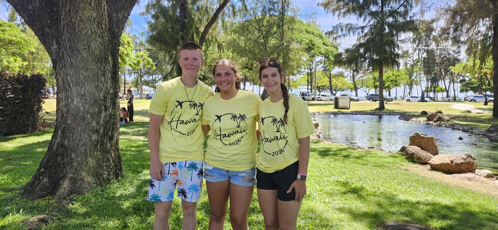 Students stand in Hawaii posed and smiling