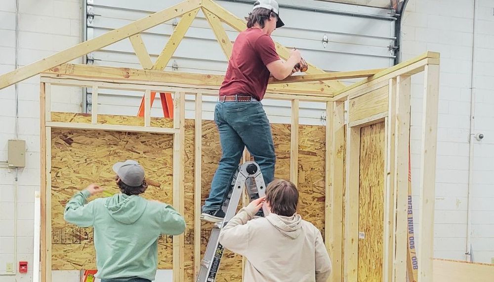 Students building a construction "trainer" model.