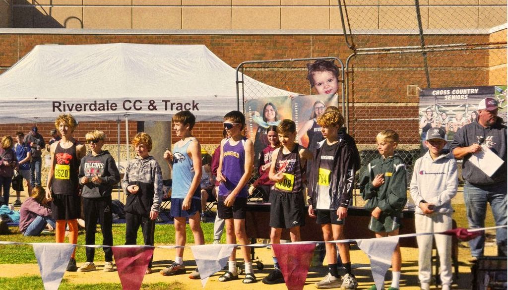Aaron stands with other students at the conclusion of the cross country race.