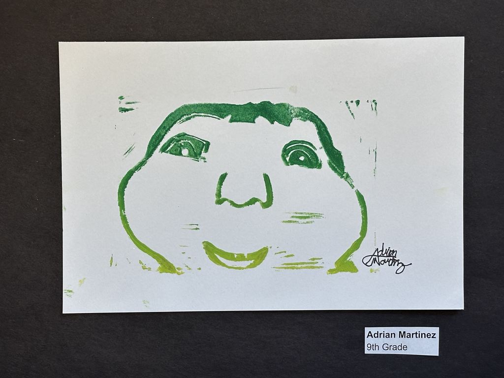 Green and yellow print of a face by Adrian Martinez
