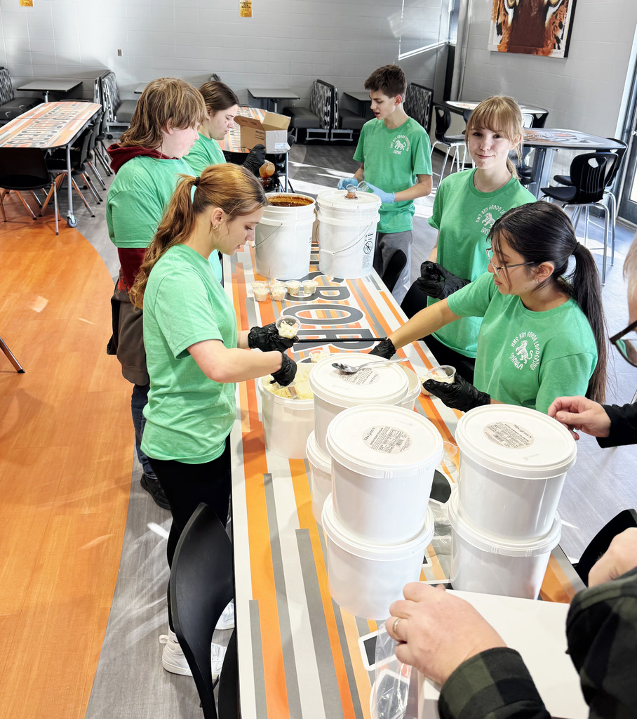 Students serving meal in cafeteria