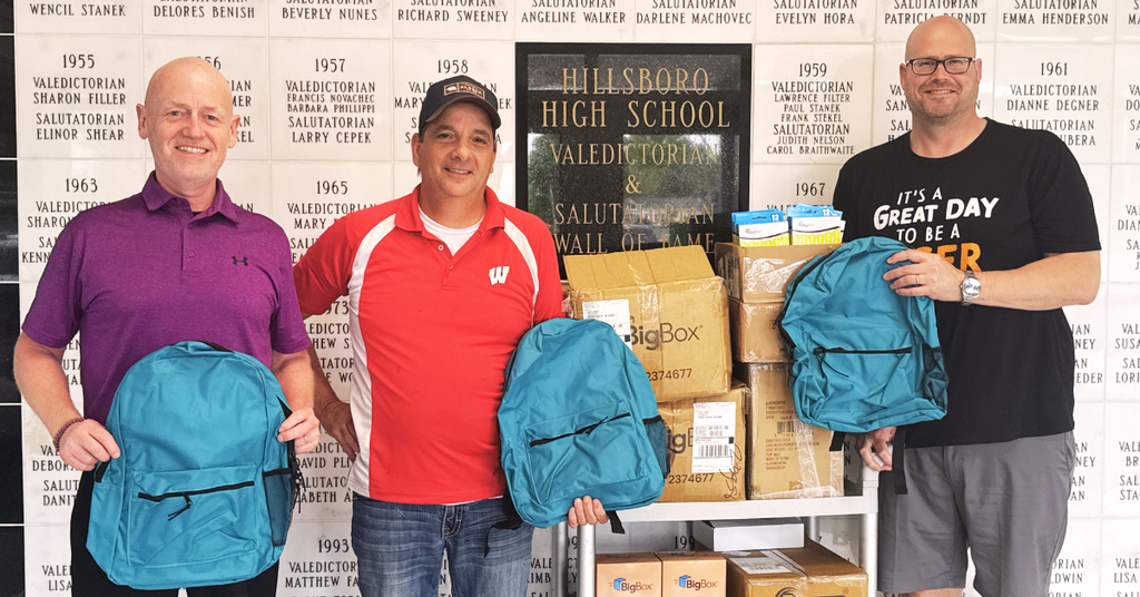 Principal, Land O Lakes representatives, and Superintendent pose with donated supplies