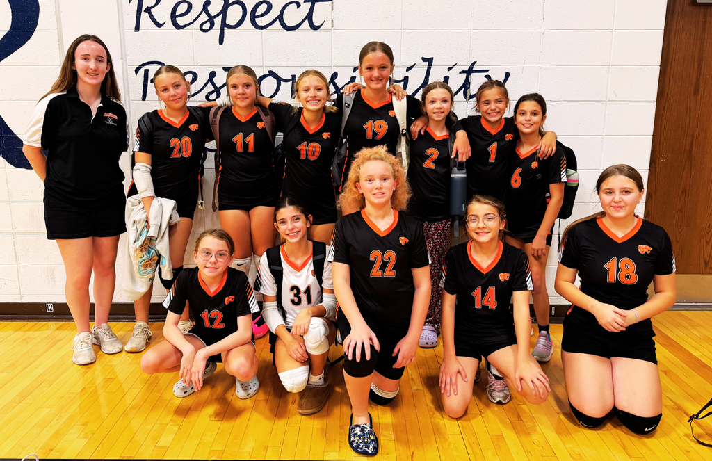 Middle School volleyball players pose