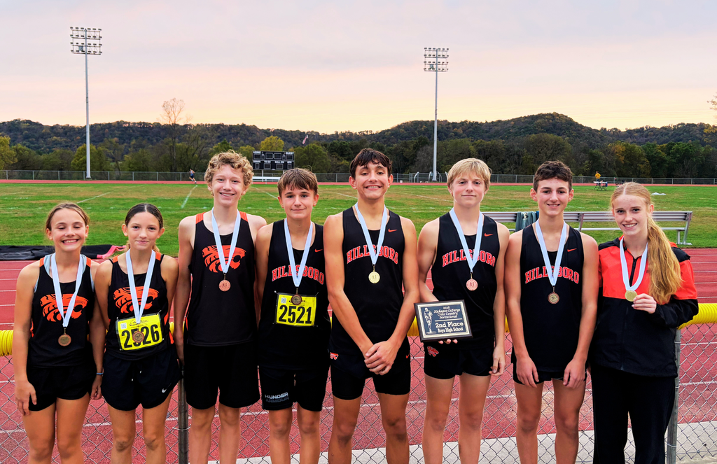 Middle and HIgh School Cross Country students pose with medals