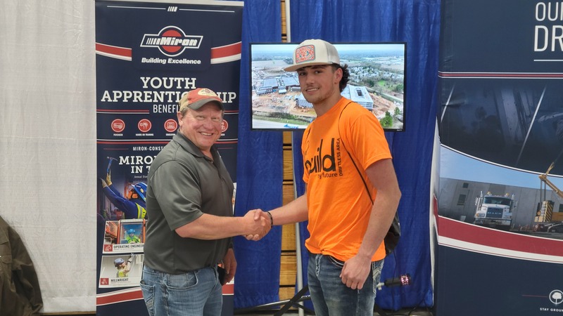 Student shaking hands with apprentice mentor