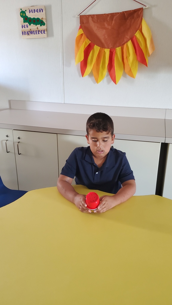Student playing with cups