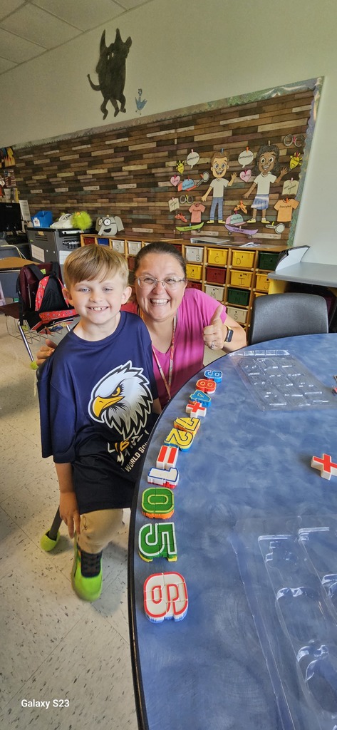 student with teacher doing math problem