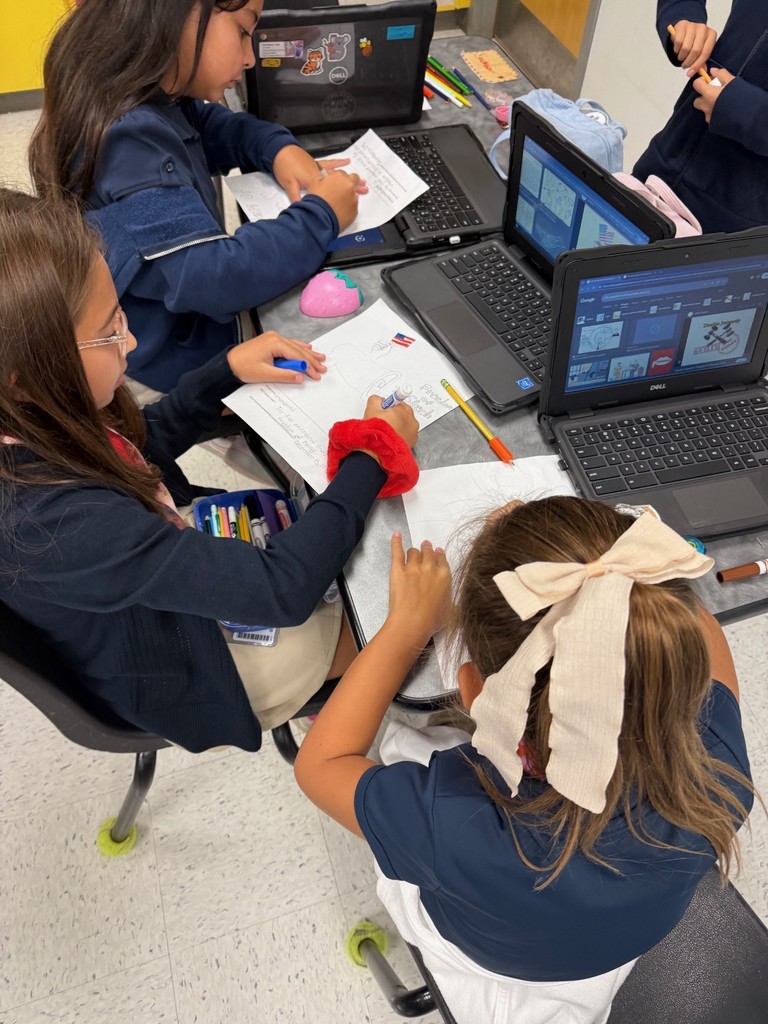 students collaborating and drawing flags