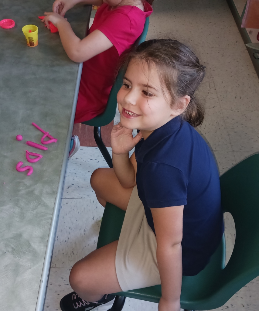 students spelling words with playdoh