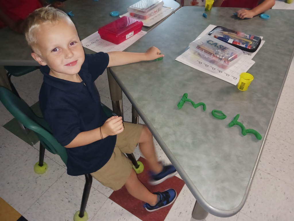 students spelling words with playdoh