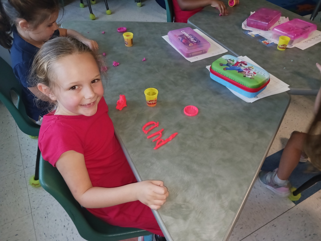 students spelling words with playdoh