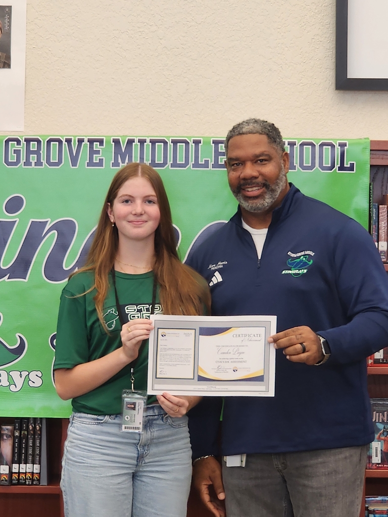 Student and Principal holding award
