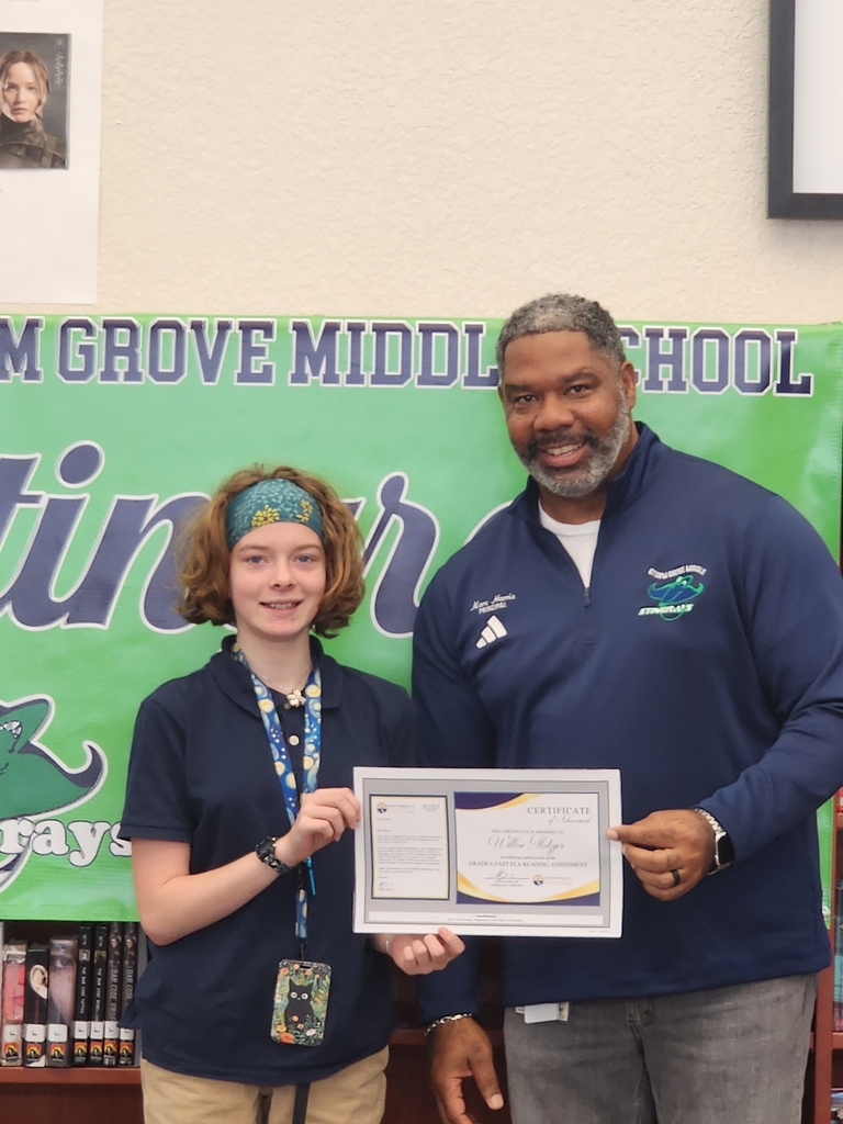 Student and Principal holding award