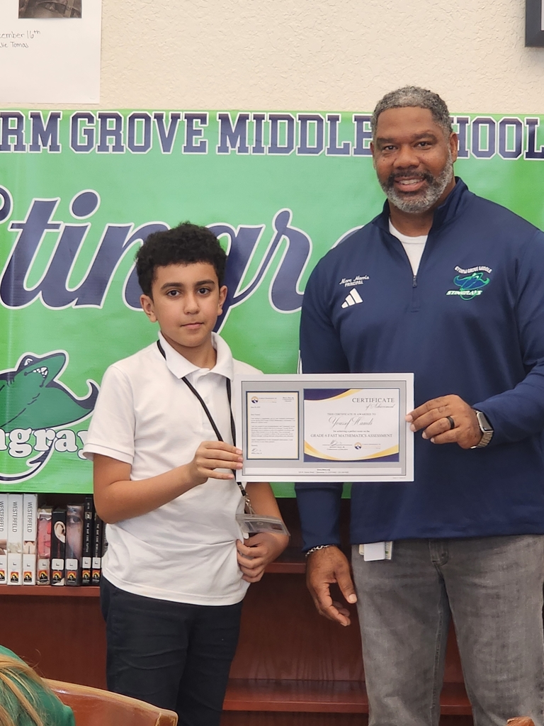 Student and Principal holding award